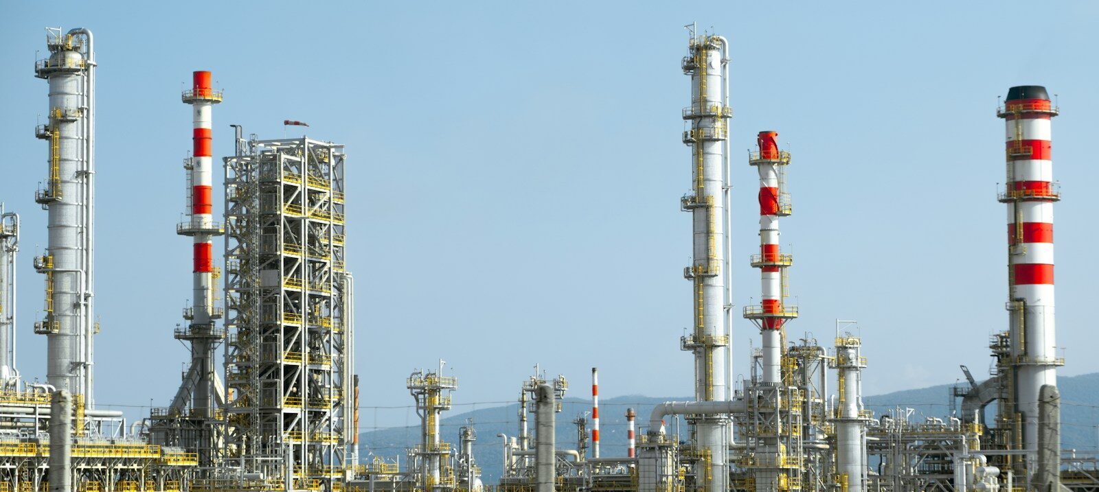 A factory with a lot of red and white pipes